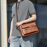 Stylish travel bag worn by a person in a striped polo shirt, showcasing smart storage and a professional look.